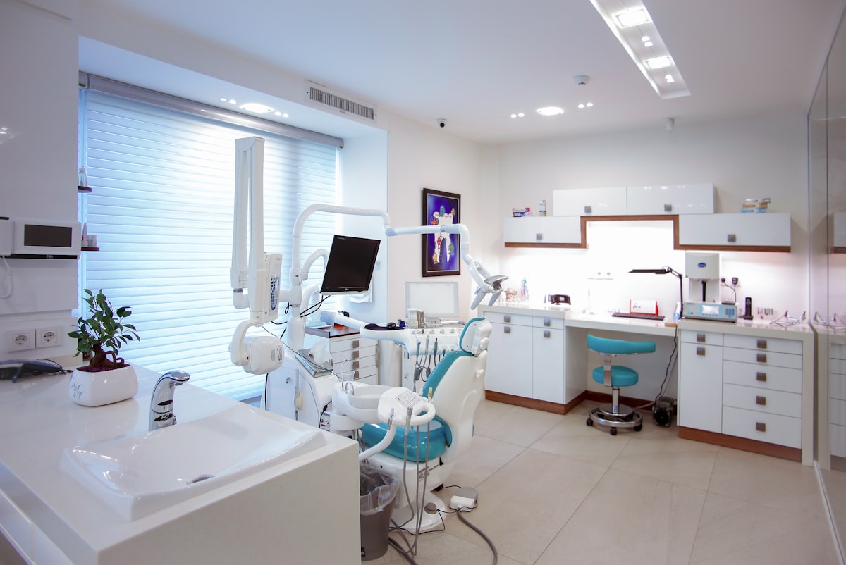 Modern dental exam room with treatment chair and equipment