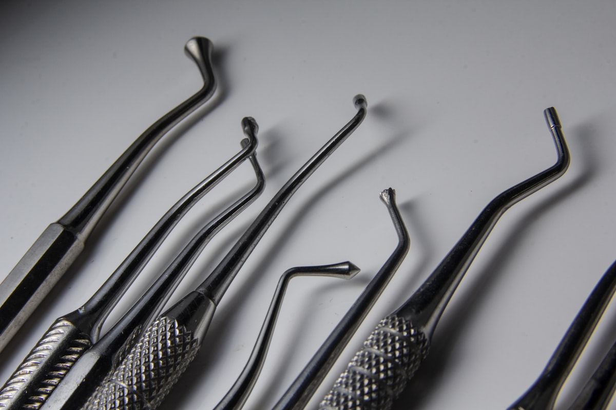 Dental instruments arranged on a white surface