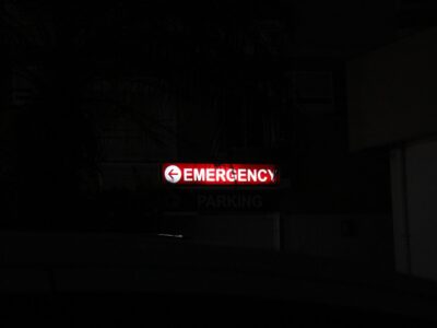 Red emergency sign glowing at night
