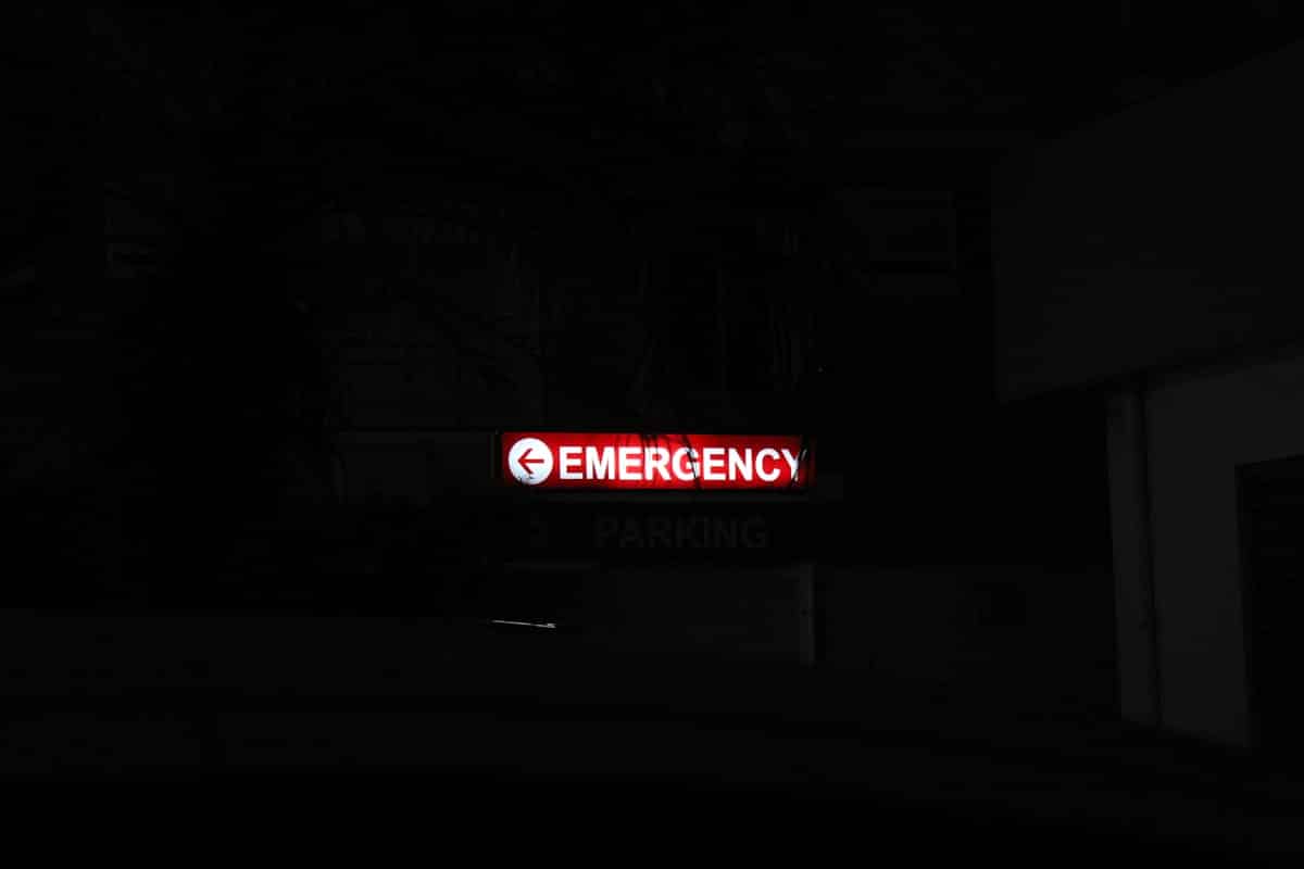Red emergency sign glowing at night
