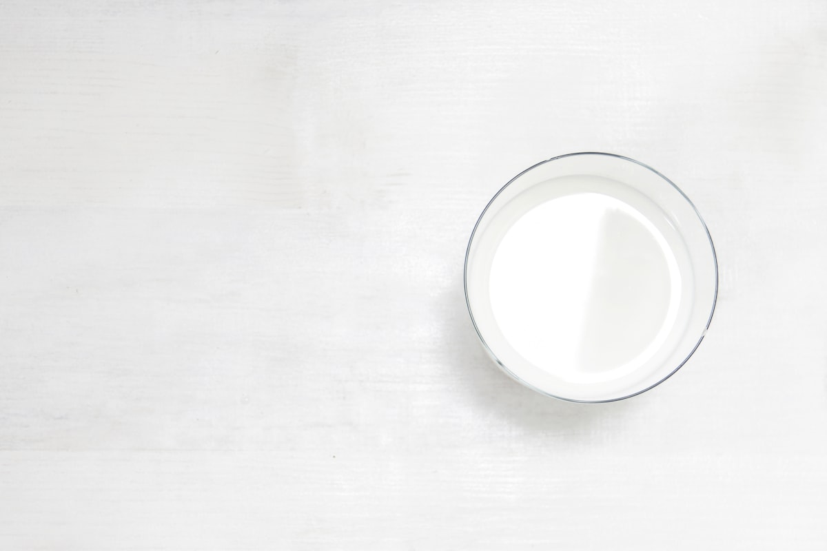 Glass of milk on a white table