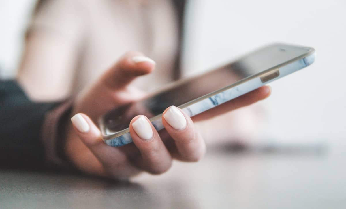 Hand holding a phone to make a call