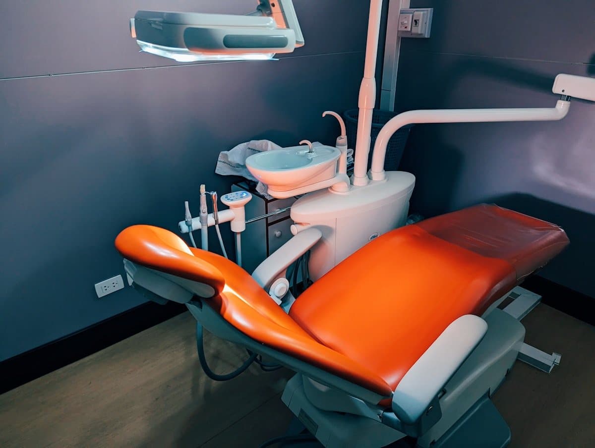 Dental chair and overhead light in a treatment room