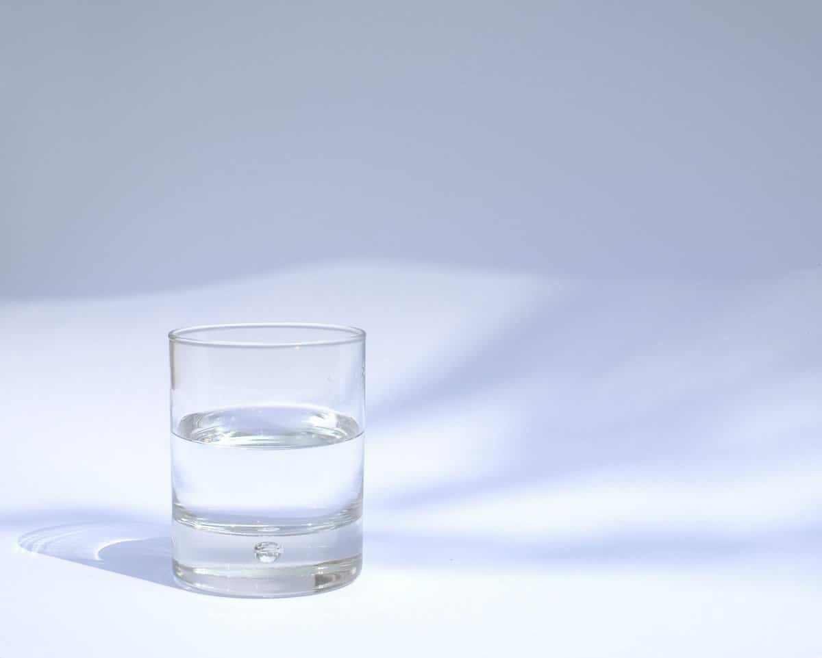 Glass of water on a plain surface, where dentures rest overnight