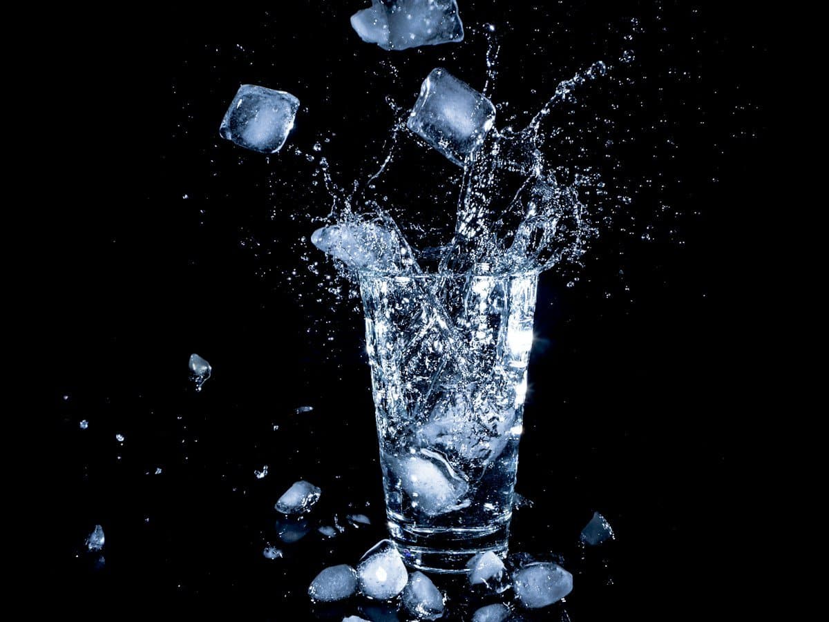 Ice cubes splashing into a glass of water, cool drinks are fine after an implant, straws are not