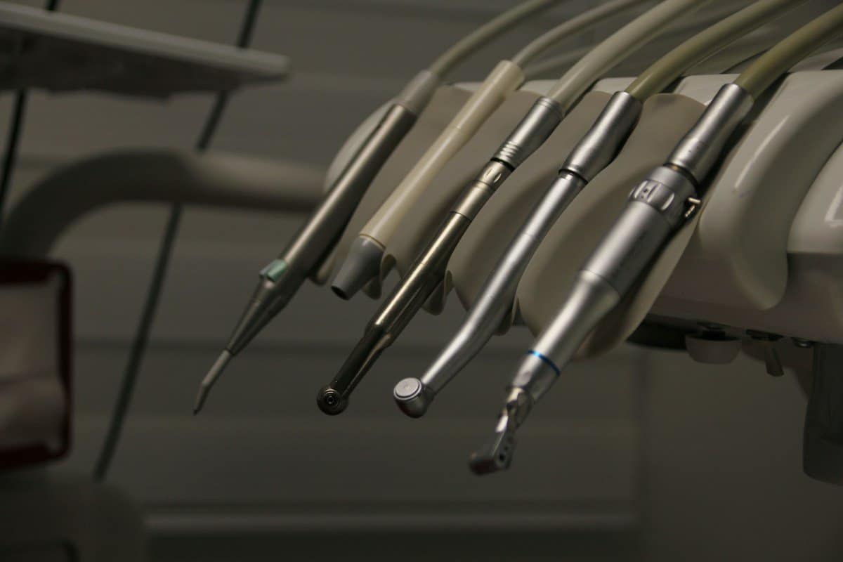 Dental handpieces on a treatment unit in a dim room
