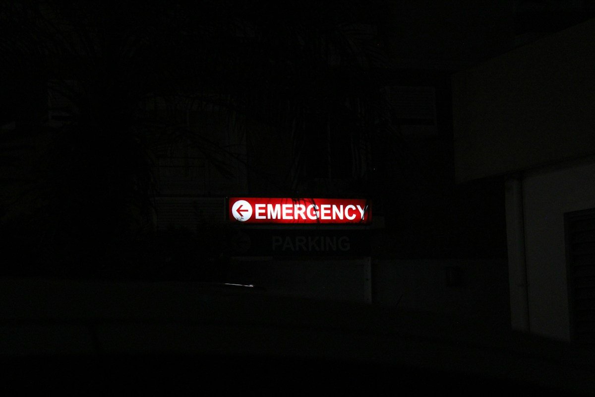 Red emergency sign lit up at night