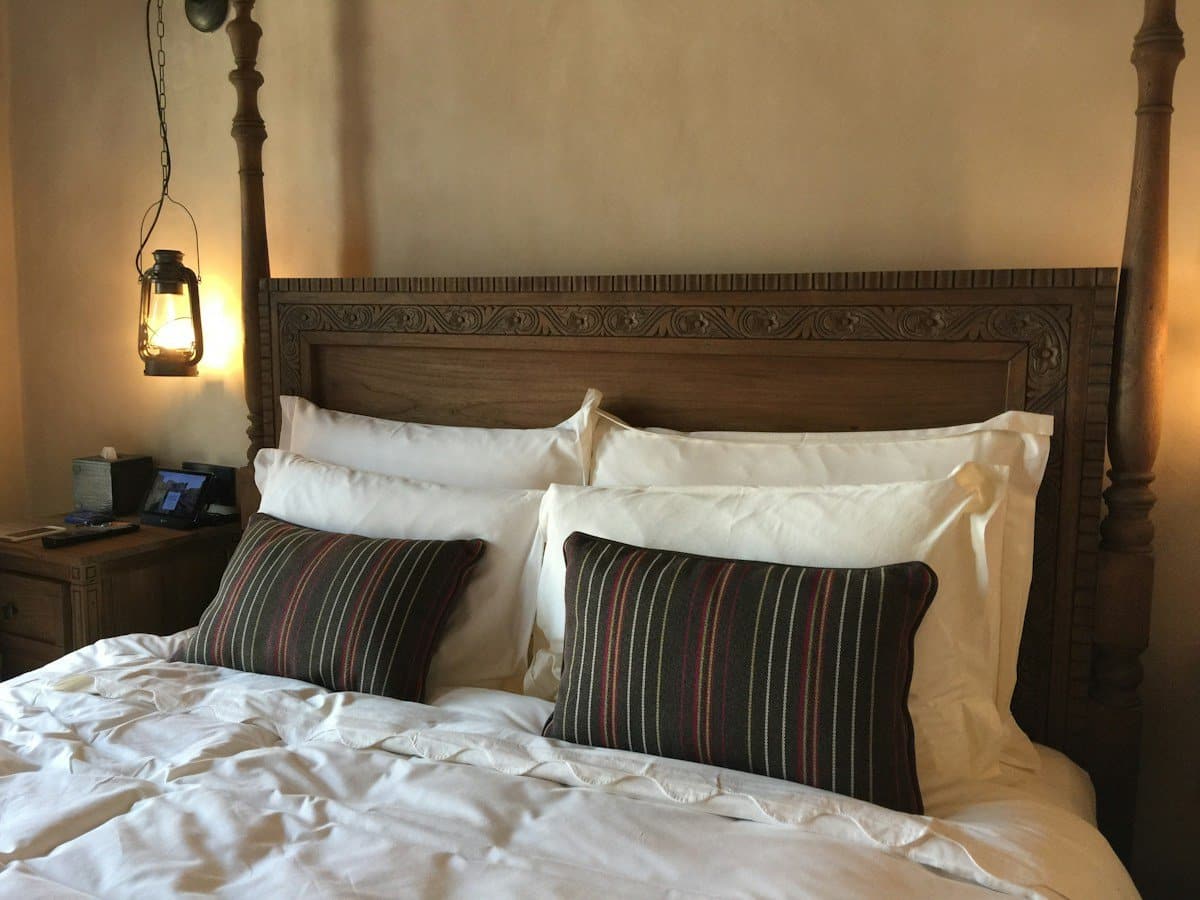 Bed with pillows and a lit lantern, a tooth infection after hours